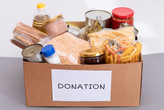 Donation Box of Free Food. Carton Box with Canned Food, Cereals and Grocery. Meal Reserves. Emergency Food Storage in Case of Crisis. Free Social Help, Blessings and Care. Strategic Food Supplies photo