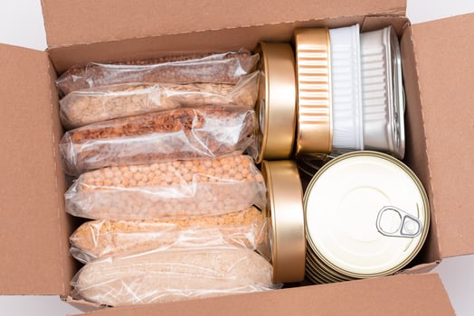 Food Reserves or Donation Box. Carton Box with Canned Food, Cereals and Grocery. Emergency Food Storage in Case of Crisis. Free Social Help, Blessings and Care. Strategic Food Supplies photo