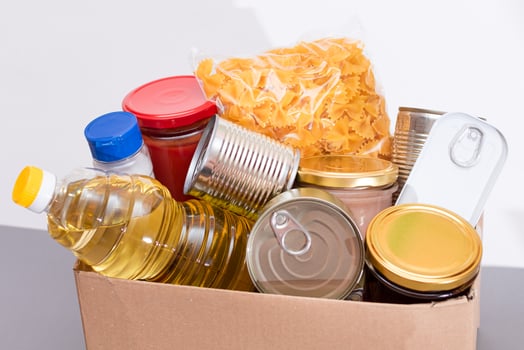 Donation Box of Free Food. Carton Box with Canned Food, Cereals and Grocery. Meal Reserves. Emergency Food Storage in Case of Crisis. Free Social Help, Blessings and Care. Strategic Food Supplies photo