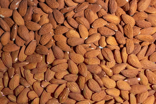 Scattered Almonds. Background from Almond Nuts. Natural High-Calorie Snacks photo