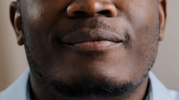 Extreme close up happy male smiling face african american young man positive male model ethnic guy smile toothy with white healthy teeth advertisement after stomatological treatment dental procedure photo