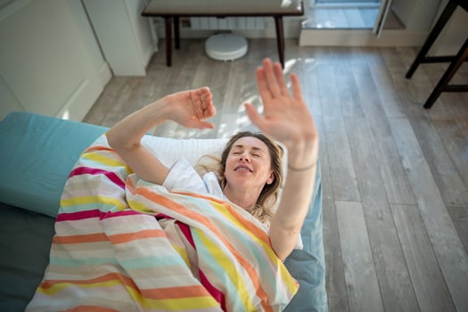 Relaxed woman closes hand and want to stay in bed in morning. Early wake up, sleep interruption photo
