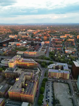 Aerial View of Greater Manchester City Centre and Tall Buildings During Golden Hour of Sunset. England UK. High Angle Footage Was Captured with Drone's Camera During Windy day of May 5th, 2024 photo