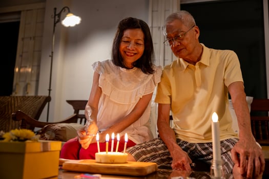 Senior asian couple is happily celebrating birthday together at home for love, relationship, bonding, longevity and marriage photo
