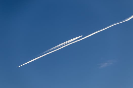 Contrails - two planes flying in opposite directions with condensation trails photo