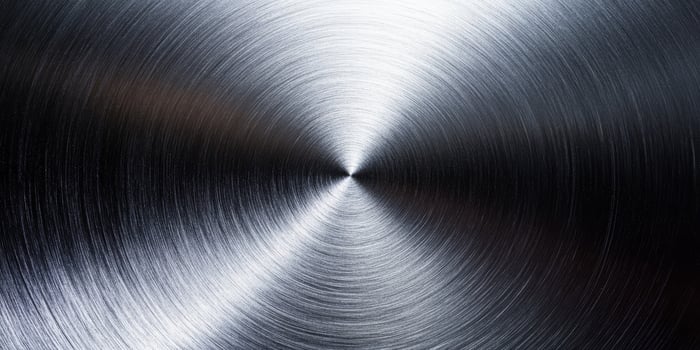 The design has a captivating metallic silver background with a polished texture, perfect for showcasing industrial themes, especially those reflecting stainless steel and aluminum finishes photo