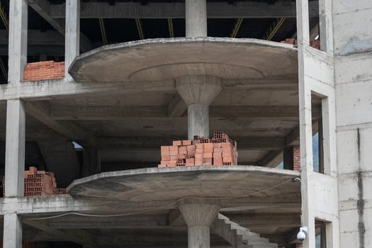 Partially constructed concrete building with exposed brickwork highlighting urban development challenges and construction themes photo