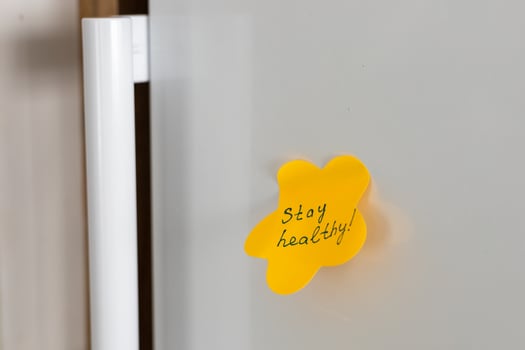 Sticky note reminder on refrigerator door encouraging healthy habits and lifestyle choices photo