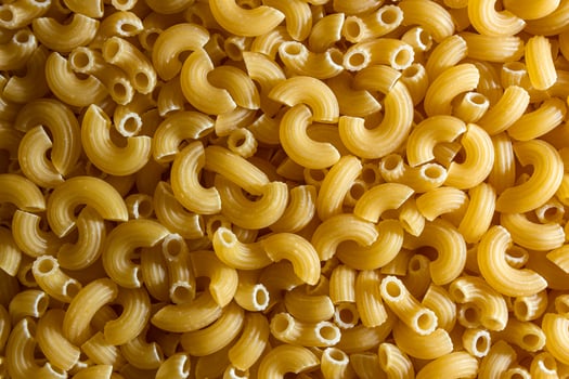 Uncooked Chifferi Rigati Pasta. A Culinary Canvas of Chifferi Rigati, Creating a Lively and Textured Background for Gourmet Cooking. Dry Pasta. Raw Macaroni - Top View, Flat Lay photo