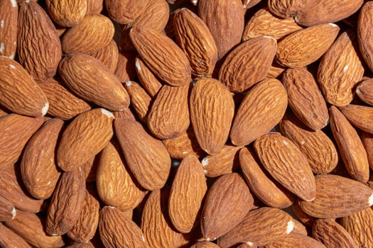 Scattered Almonds. Background from Almond Nuts. Natural High-Calorie Snacks photo