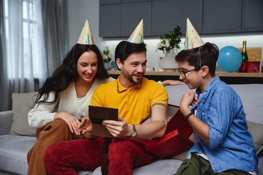 Family celebration at home with kids enjoying gifts on a joyful occasion photo