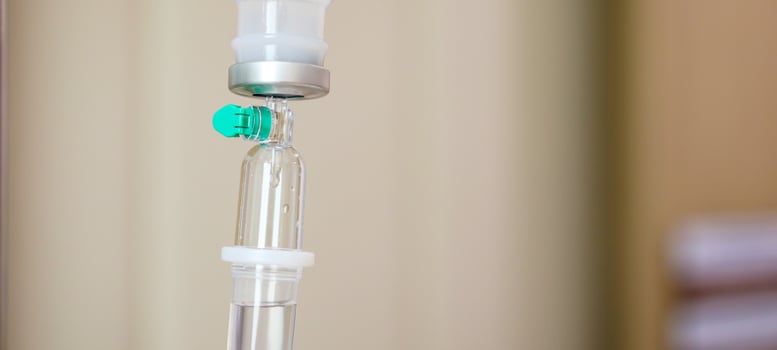 Close up medical intravenous IV drip in hospital background photo
