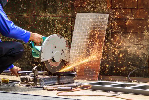 worker using electric fiber circle cutting machine cutting the steel bars photo