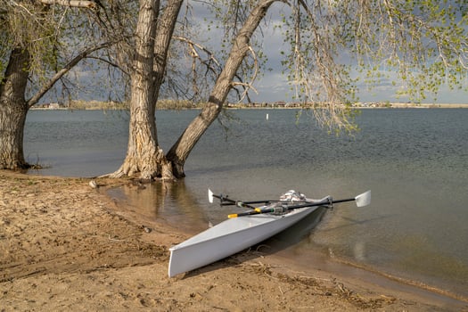 Coastal rowing shell on a shore of Boyd Lake in northern Colorado in early spring scenery. photo