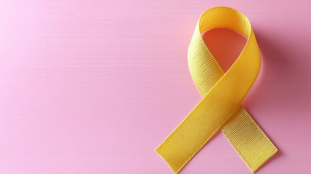 A bold yellow ribbon symbolizes support and awareness on a pink background photo