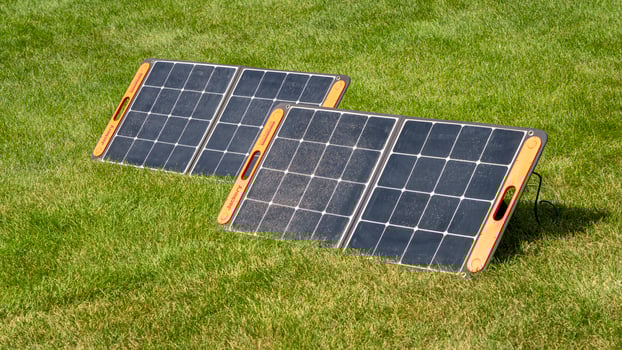 Loveland, CO, USA - August 25, 2024, Two portable Jackery solar panels on a grassy field. photo