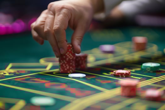 A person is placing chips on a roulered table photo