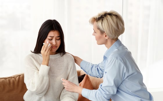 Family Therapy. Psychologist Comforting Desperate Wife Crying Near Indifferent Husband At Psychotherapy Session Indoor photo