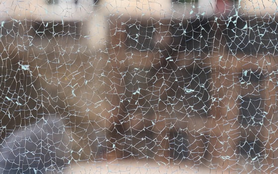 Cracked clear glass full frame. Close up photo