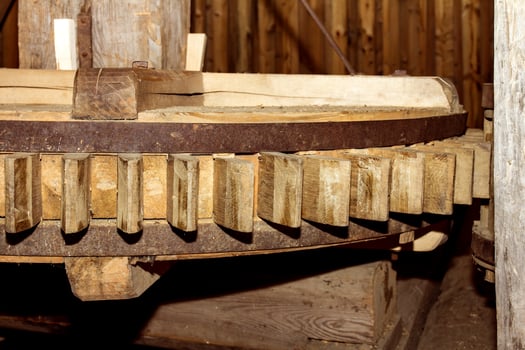 Close up of wooden flywheel of an old mill for grinding grain into flour photo