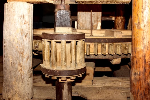 Close up of some wooden flywheel of an old mill for grinding grain into flour photo