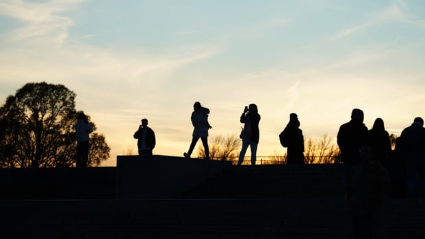 The beautiful sunset view with the silhouettes of the people photo