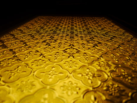 A golden metal door with a pattern on it photo
