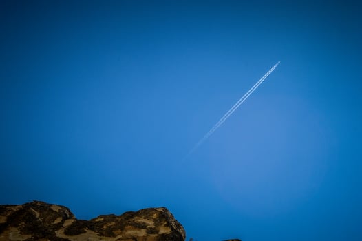 A jet plane flying through the blue sky photo