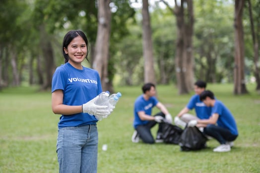 Volunteer Team Collecting Trash in Park to Promote Environmental Awareness and Community Cleanliness photo