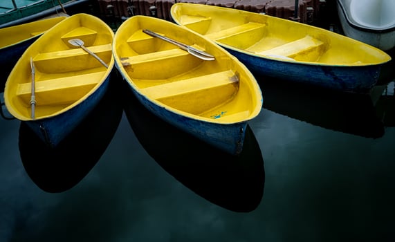 Three boats are docked at a dock photo