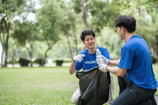 Volunteers Collecting Trash in a Park to Promote Environmental Awareness and Community Cleanliness photo