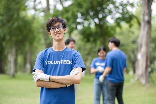 Group of Volunteers Collecting Trash in a Park to Promote Environmental Conservation and Community Service photo