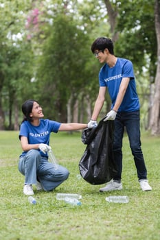 Volunteers Collecting Trash in a Park to Promote Environmental Awareness and Community Cleanliness photo