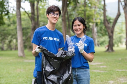 Volunteers Collecting Trash in Park to Promote Environmental Awareness and Community Cleanliness photo