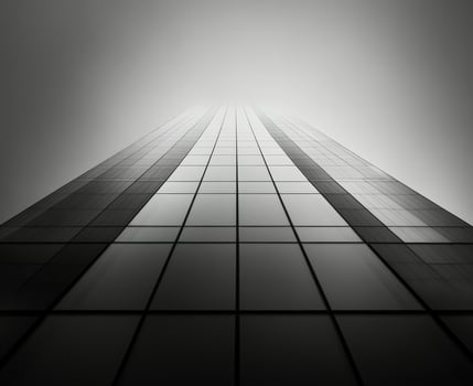 Towering skyscraper illuminated at dusk with a dramatic sky in the background photo