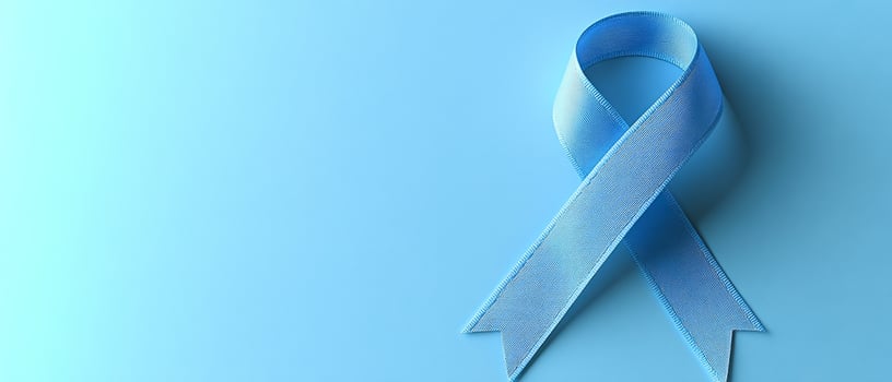 A blue ribbon with a white stripe on it. The ribbon is meant to represent breast cancer awareness photo
