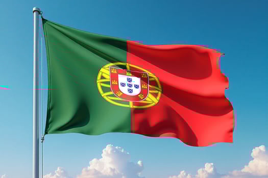Portugal Flag Waving Against Clear Blue Sky photo