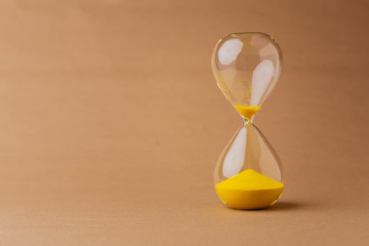 Hourglass, a timepiece, the rules of time and the rush of work, the value and meaning of time photo