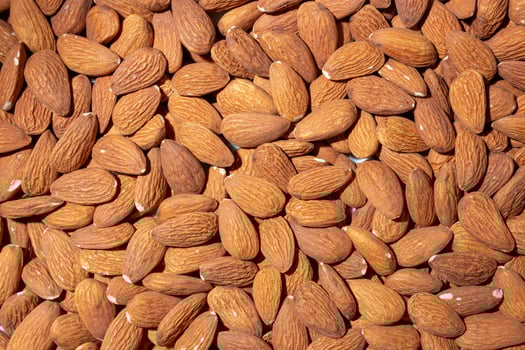 Scattered Almonds. Background from Almond Nuts. Natural High-Calorie Snacks photo