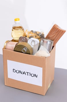 Donation Box of Free Food. Carton Box with Canned Food, Cereals and Grocery. Meal Reserves. Emergency Food Storage in Case of Crisis. Free Social Help, Blessings and Care. Strategic Food Supplies photo