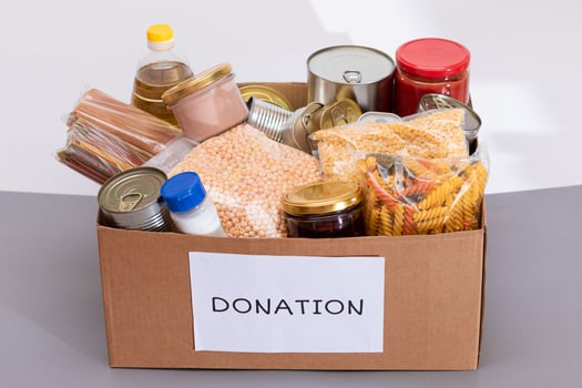 Donation Box of Free Food. Carton Box with Canned Food, Cereals and Grocery. Meal Reserves. Emergency Food Storage in Case of Crisis. Free Social Help, Blessings and Care. Strategic Food Supplies photo