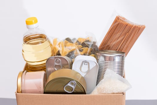 Donation Box of Free Food. Carton Box with Canned Food, Cereals and Grocery. Meal Reserves. Emergency Food Storage in Case of Crisis. Free Social Help, Blessings and Care. Strategic Food Supplies photo