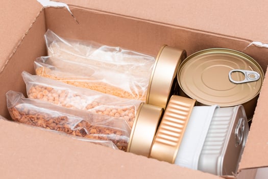 Food Reserves or Donation Box. Carton Box with Canned Food, Cereals and Grocery. Emergency Food Storage in Case of Crisis. Free Social Help, Blessings and Care. Strategic Food Supplies photo