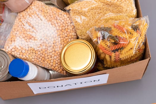 Donation Box of Free Food. Carton Box with Canned Food, Cereals and Grocery. Meal Reserves. Emergency Food Storage in Case of Crisis. Free Social Help, Blessings and Care. Strategic Food Supplies photo