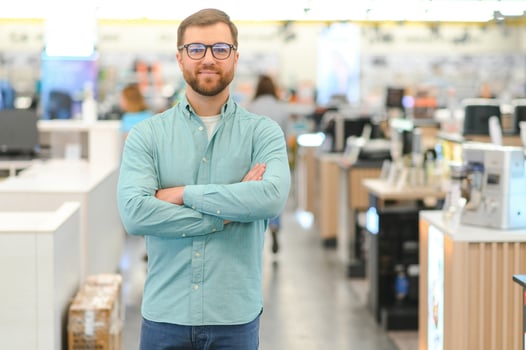 Happy man in electronics store. Big discounts photo