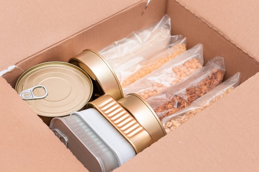 Food Reserves or Donation Box. Carton Box with Canned Food, Cereals and Grocery. Emergency Food Storage in Case of Crisis. Free Social Help, Blessings and Care. Strategic Food Supplies photo