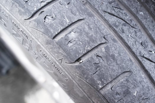 Close up of car tire tread deterioration from use , worn out a car tire , Car maintenance concept photo