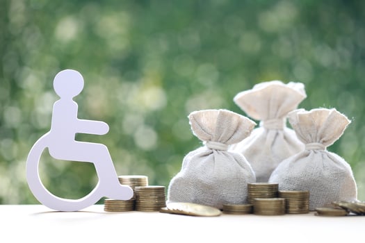 Man on wheelchair and coin money on natural green background,Save money for prepare in future and handicapped person concept photo
