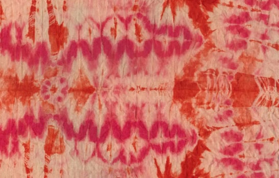 Pink brown wavy tiedye watercolor fabric background and texture photo