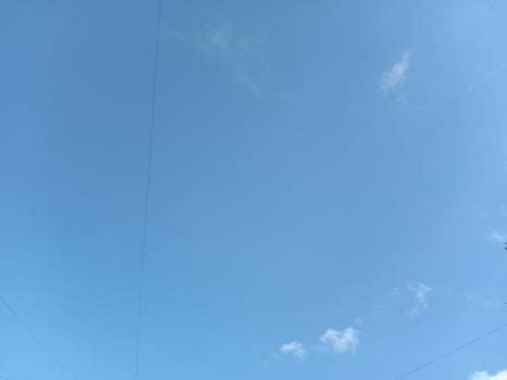 Delicate white clouds on a clear blue sky photo